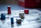 dices and wooden pieces on game board