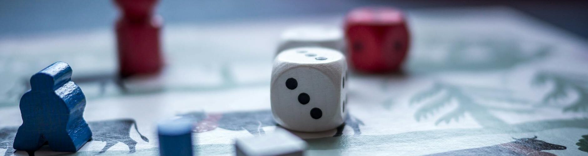 dices and wooden pieces on game board