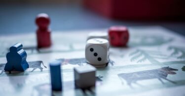 dices and wooden pieces on game board