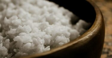 close up of steamed rice in wooden bowl
