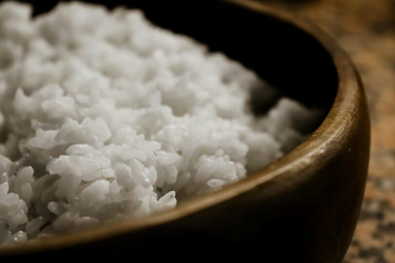 close up of steamed rice in wooden bowl
