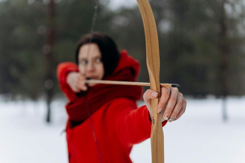 woman using wooden bow