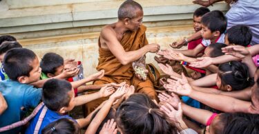 ma giving food to ground of people
